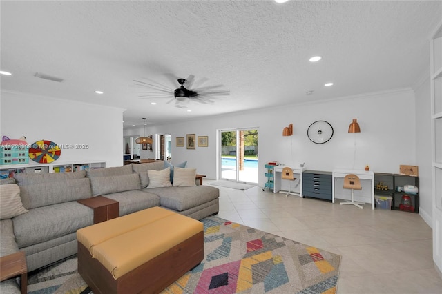 living room featuring a textured ceiling, ceiling fan, light tile patterned floors, and crown molding