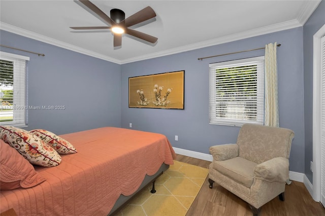 bedroom featuring ceiling fan, ornamental molding, and light hardwood / wood-style flooring