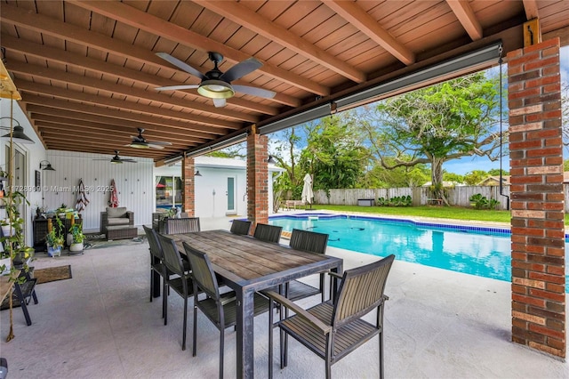 view of swimming pool featuring ceiling fan and a patio