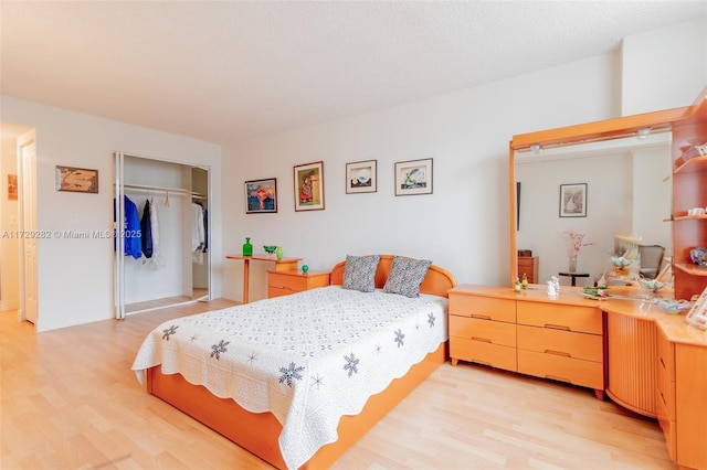 bedroom with a closet and light hardwood / wood-style flooring