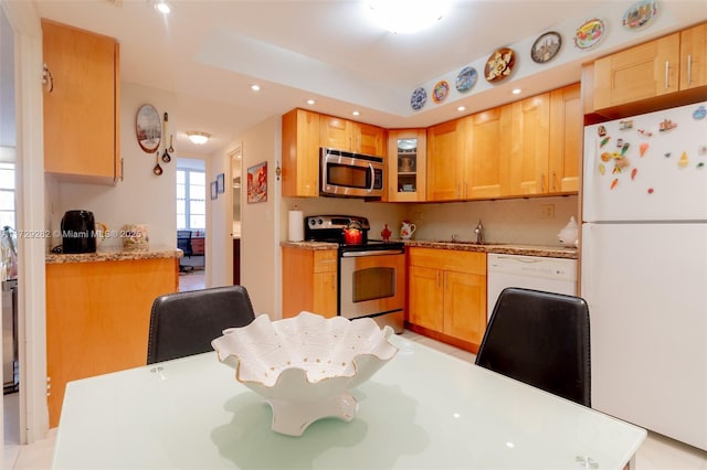 kitchen with light brown cabinetry, appliances with stainless steel finishes, and sink