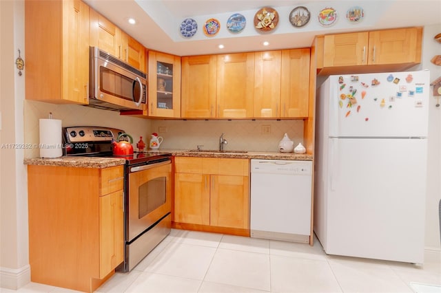 kitchen featuring decorative backsplash, sink, appliances with stainless steel finishes, and light tile patterned flooring