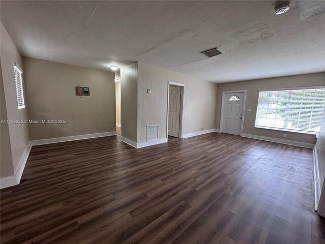 kitchen with white cabinets, appliances with stainless steel finishes, sink, and dark hardwood / wood-style flooring