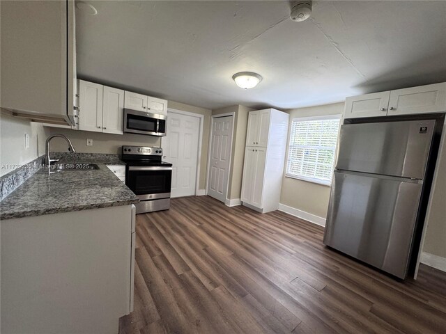 empty room featuring dark hardwood / wood-style flooring and a wealth of natural light