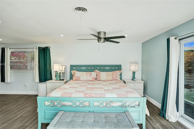 bedroom featuring ceiling fan, wood-type flooring, and multiple windows