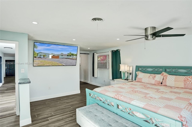 bedroom with ceiling fan and dark wood-type flooring