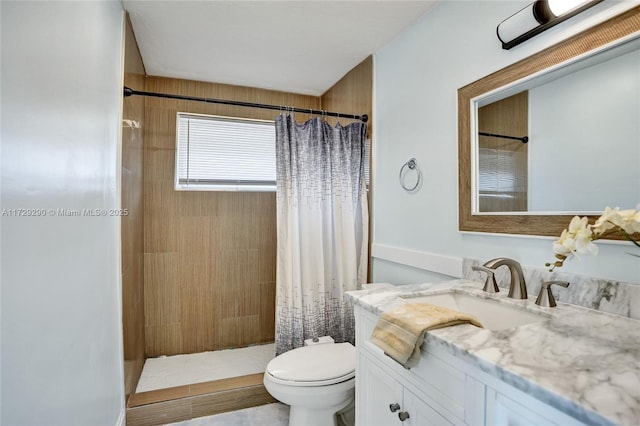 bathroom with toilet, vanity, and a shower with shower curtain