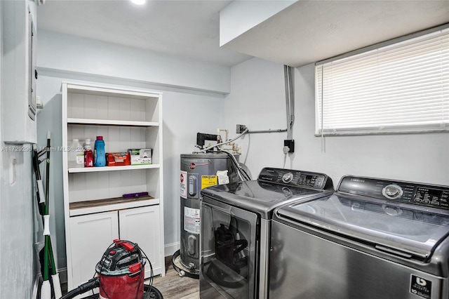 laundry area with water heater, washer and clothes dryer, and hardwood / wood-style flooring