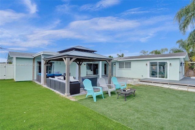 back of house featuring a gazebo, a yard, an outdoor living space, and a patio