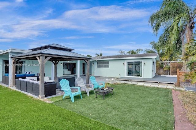 rear view of house with a gazebo, a yard, and an outdoor living space