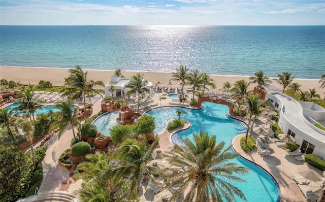 drone / aerial view featuring a water view and a beach view