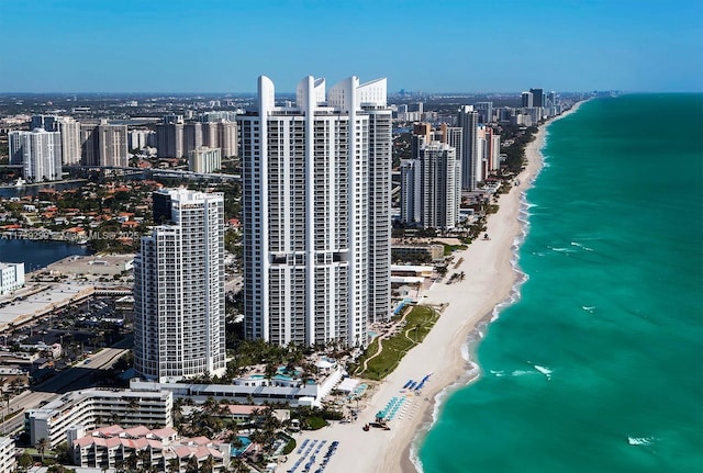 drone / aerial view featuring a view of the beach and a water view