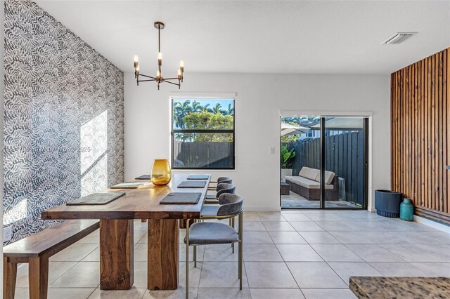 tiled dining room featuring a notable chandelier