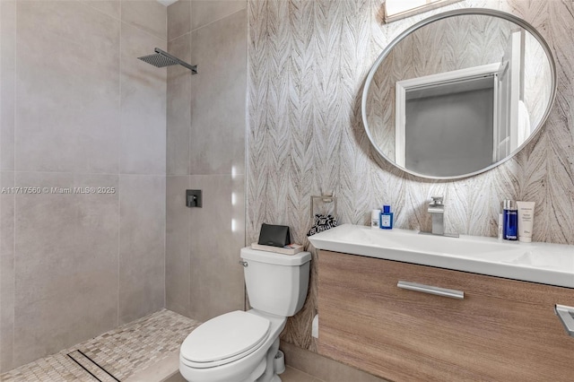 bathroom with toilet, a shower, and vanity