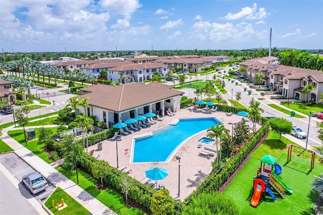 view of pool featuring a patio and a playground