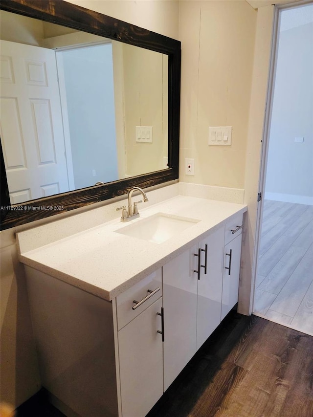 bathroom with vanity and hardwood / wood-style floors