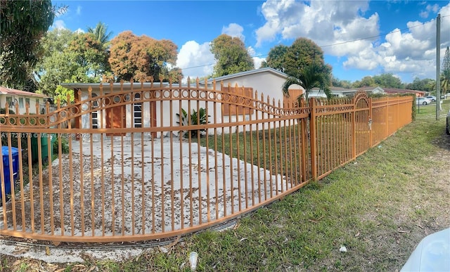 view of gate featuring a lawn