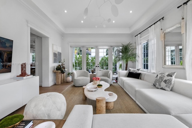 living room featuring hardwood / wood-style flooring, ornamental molding, and french doors