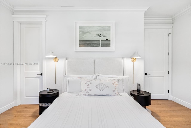 bedroom featuring crown molding and light hardwood / wood-style flooring