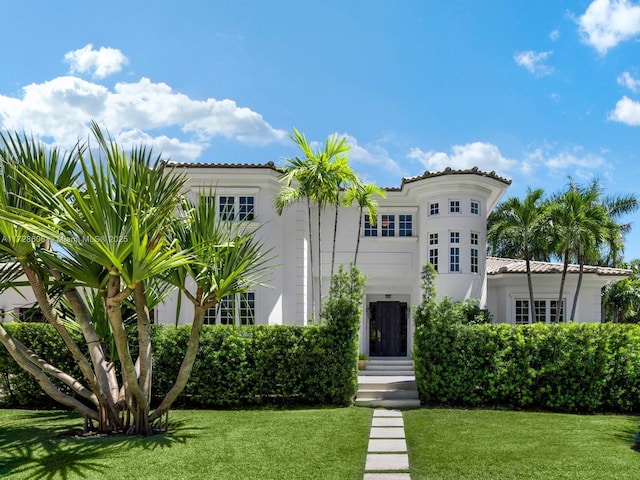 mediterranean / spanish-style home featuring a front lawn