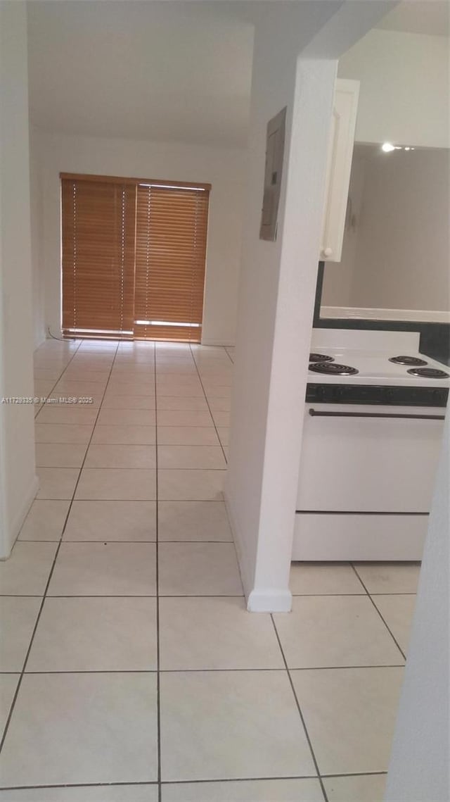 hallway with light tile patterned floors and electric panel