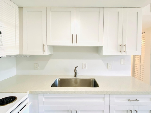 kitchen with sink and white cabinetry