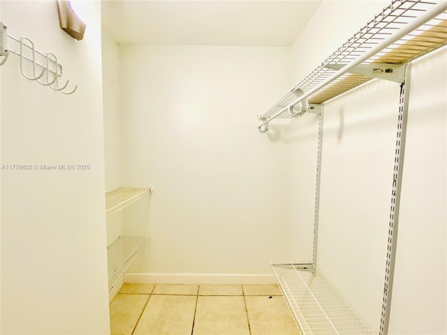 spacious closet featuring light tile patterned floors