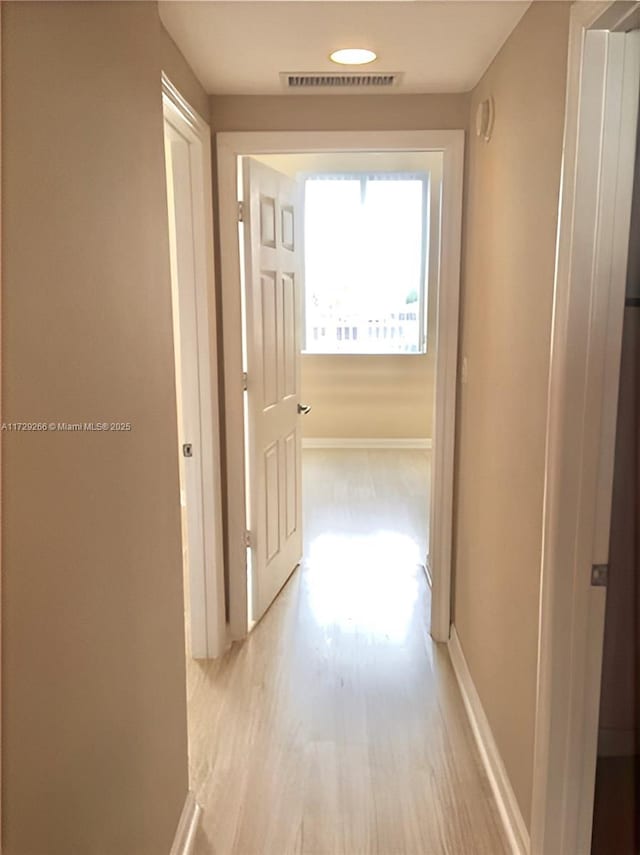 hallway with light wood-type flooring