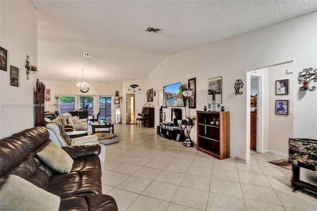 living room with vaulted ceiling, light tile patterned flooring, a notable chandelier, and a textured ceiling