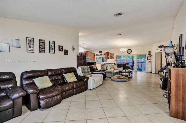 tiled living room featuring a textured ceiling and a notable chandelier