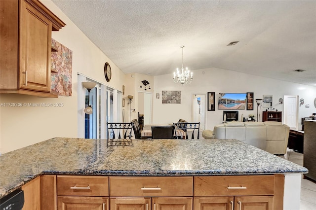 kitchen with vaulted ceiling, stone countertops, dishwasher, a notable chandelier, and a textured ceiling