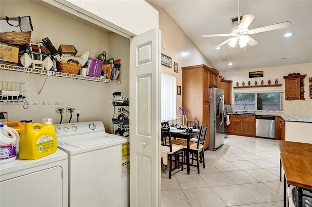 laundry area featuring sink, light tile patterned floors, washing machine and clothes dryer, and ceiling fan