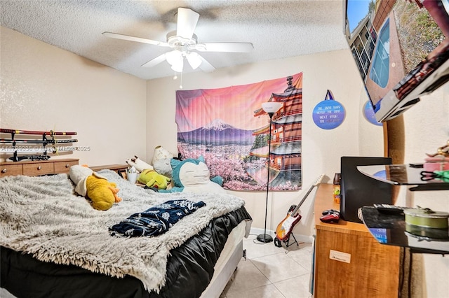 tiled bedroom with a textured ceiling and ceiling fan