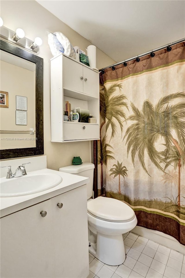 bathroom with vanity, tile patterned floors, and toilet