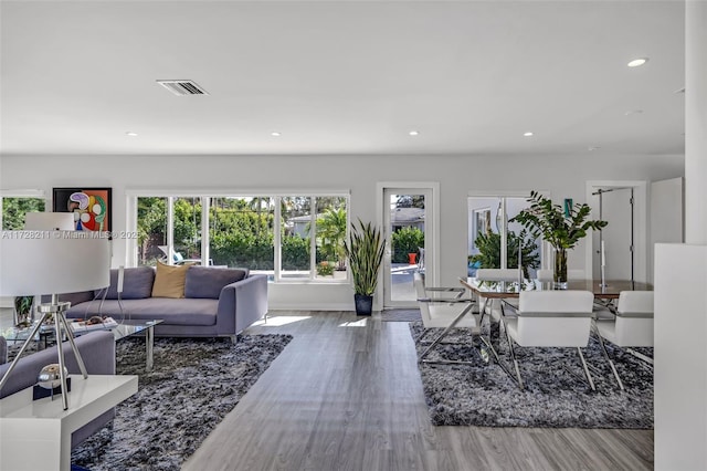living room featuring wood finished floors, visible vents, and recessed lighting