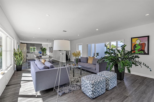 living room featuring a healthy amount of sunlight, visible vents, wood finished floors, and recessed lighting