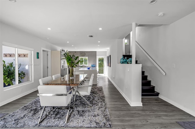 dining area with dark wood-type flooring, recessed lighting, visible vents, and stairs