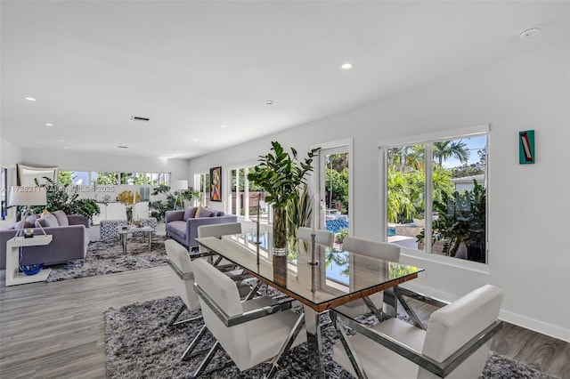 dining area with recessed lighting, wood finished floors, a wealth of natural light, and baseboards