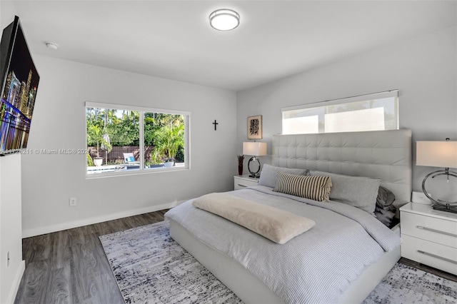 bedroom featuring baseboards and wood finished floors