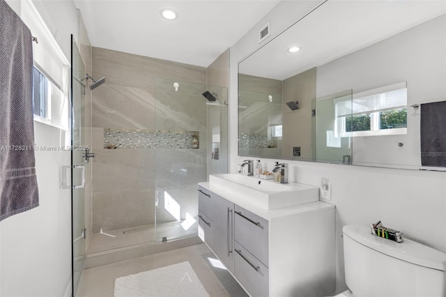 full bathroom with toilet, recessed lighting, visible vents, vanity, and a stall shower
