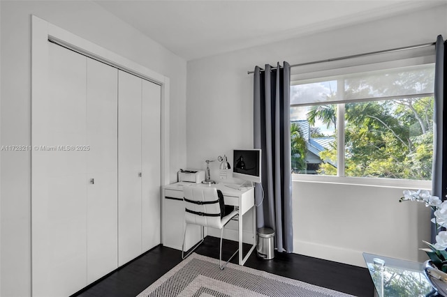 office area with baseboards and dark wood finished floors