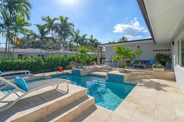 view of pool featuring a patio area, a jacuzzi, an outdoor living space, and a fenced in pool