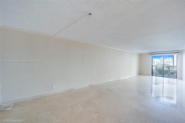 spare room with a textured ceiling and ornamental molding