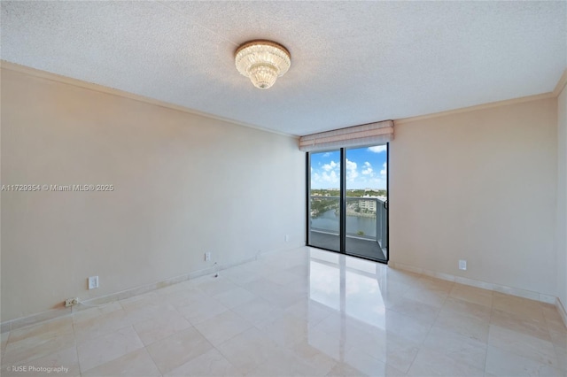 empty room with crown molding and a textured ceiling