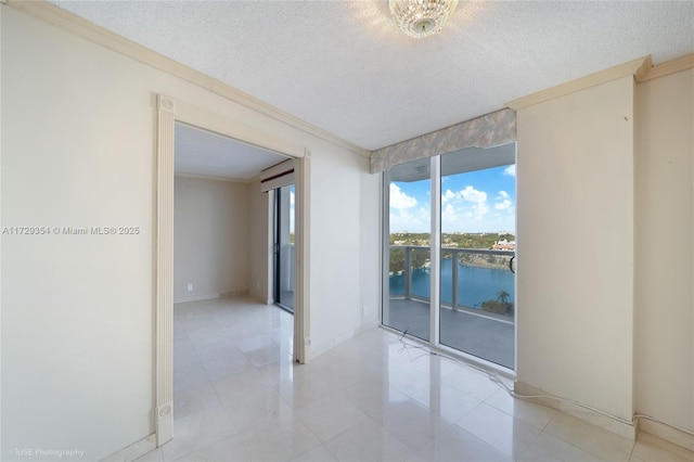 tiled empty room with a textured ceiling, crown molding, and a water view