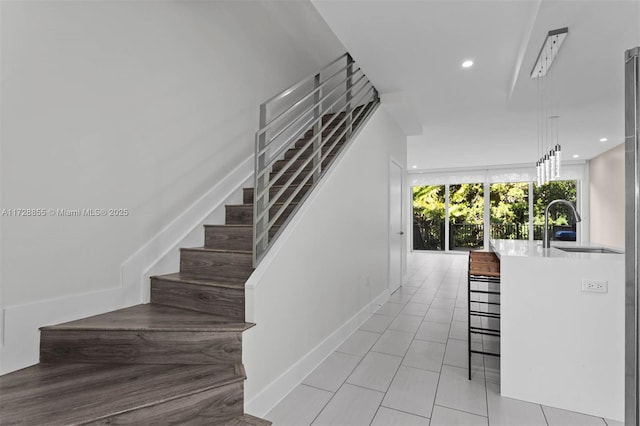 stairs with sink and tile patterned floors