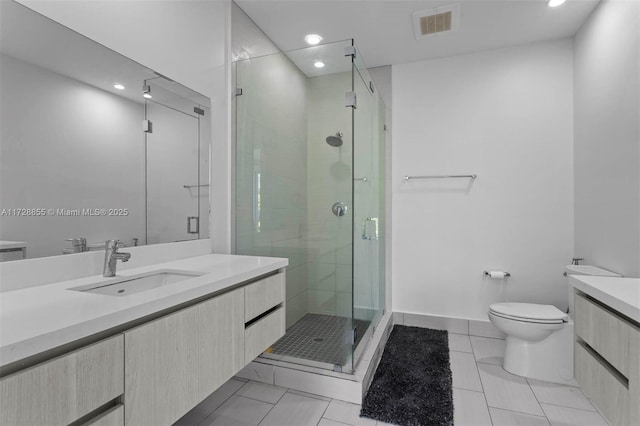 bathroom featuring toilet, a shower with door, tile patterned floors, and vanity