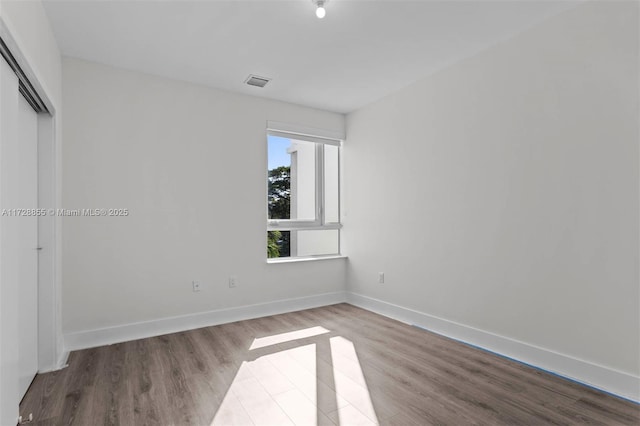 spare room featuring light hardwood / wood-style floors