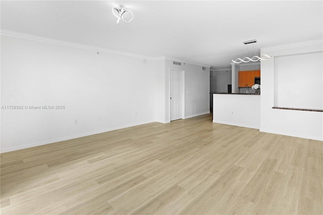 unfurnished living room with a textured ceiling, crown molding, and light wood-type flooring