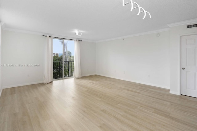 empty room featuring crown molding, a textured ceiling, and light hardwood / wood-style floors